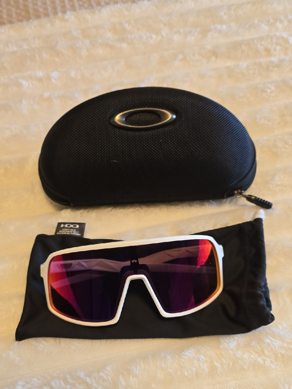 Oakley Sutro sunglasses featuring a white frame and reflective red lens